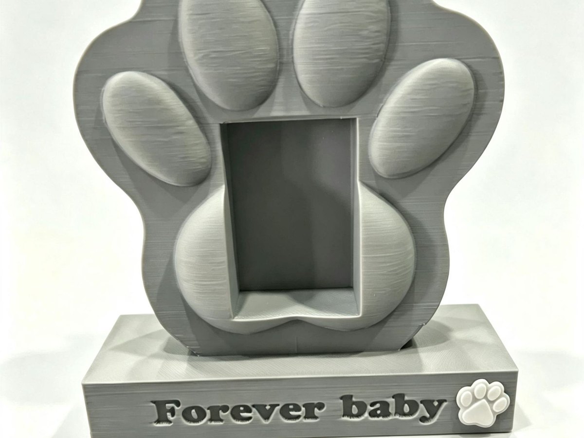 Cast stone effect paw shaped memorial marker engraved with the words Forever Baby