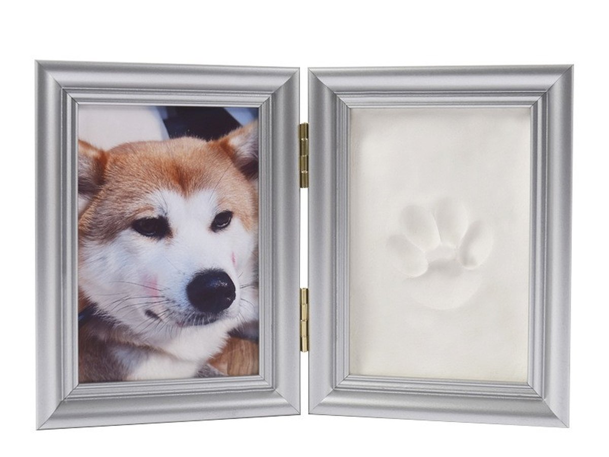 Silver double frame holding a white clay paw print beside a photo of a dog