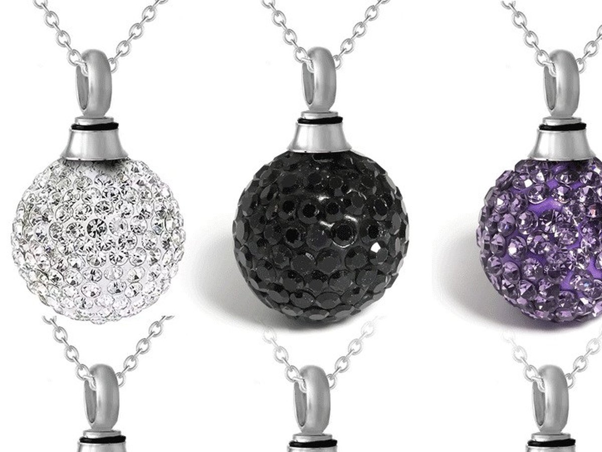 Three crystal urn pendants in white, black and purple, each on a silver chain