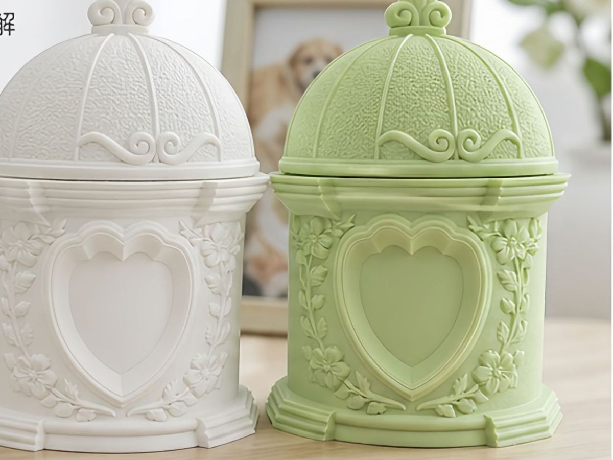 Biodegradable plant based garden urn with a domed lid and a heart panel