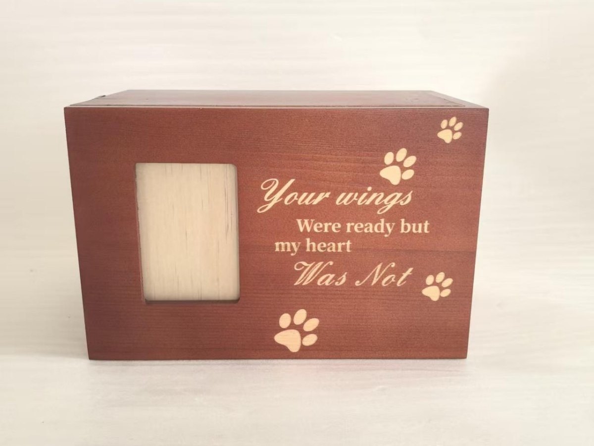 Solid wood pet urn with an inset photo window and an engraved paw print